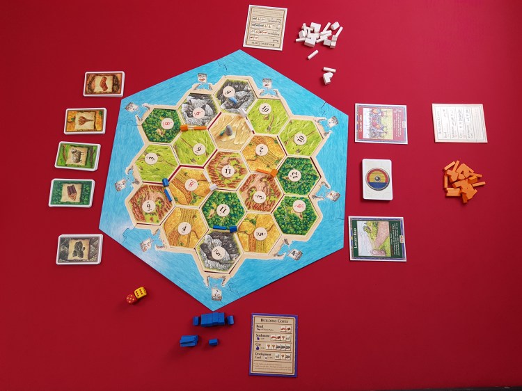 A picture of the Settlers of Catan. as the game is about to start.