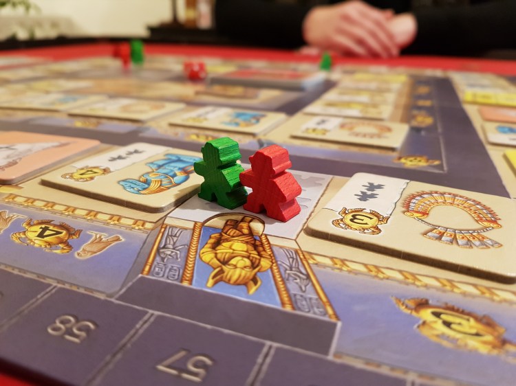 A picture of two meeples at the Luxor board.