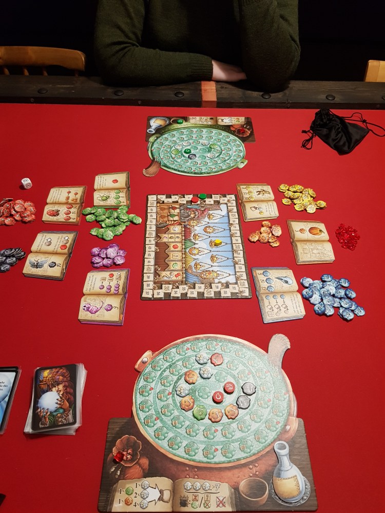 A picture of us playing the game all ingredients and player boards visible.
