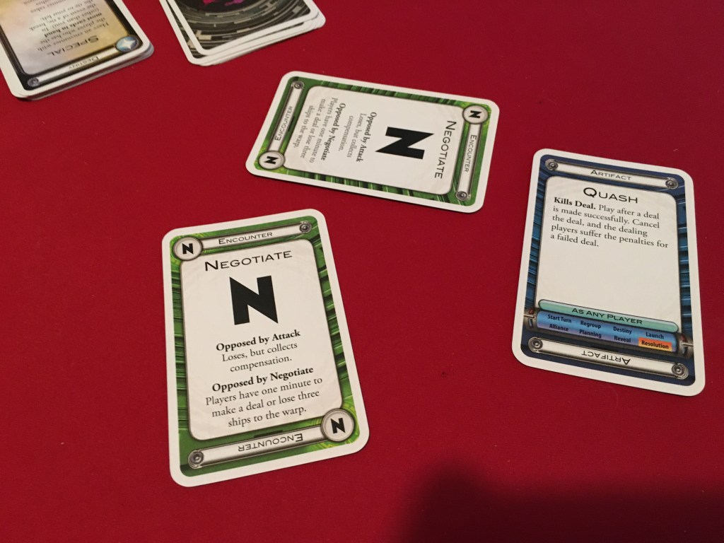 A picture of two negotiate cards and the quash card from Cosmic Encounter